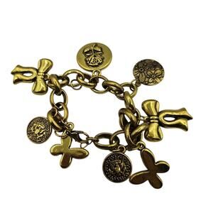 Vintage gold-toned charm bracelet featuring a variety of charms 7"
